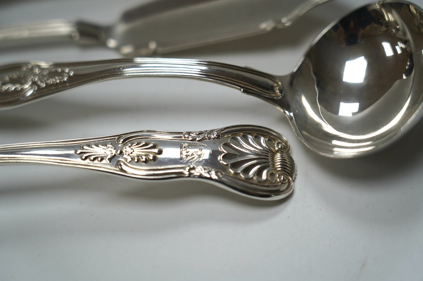 A pair of George IV silver King's pattern sauce ladles, by William Eaton, London, 1824, 17.5cm, two Victorian silver butter knives and a Victorian silver condiment spoon, 13.7cm, 10.5oz. Condition - fair to good